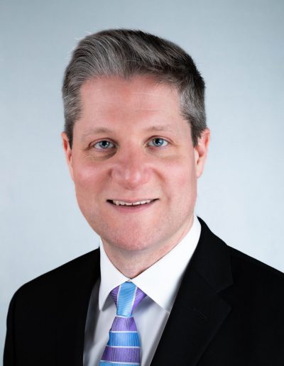 Headshot of a confident executive with strong leadership presence